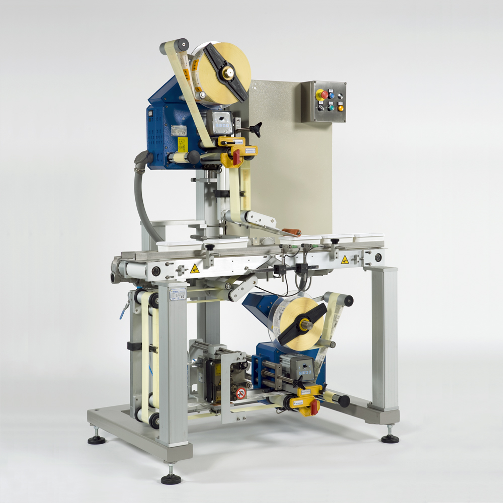 Top and bottom labelling machine for adhesive label application